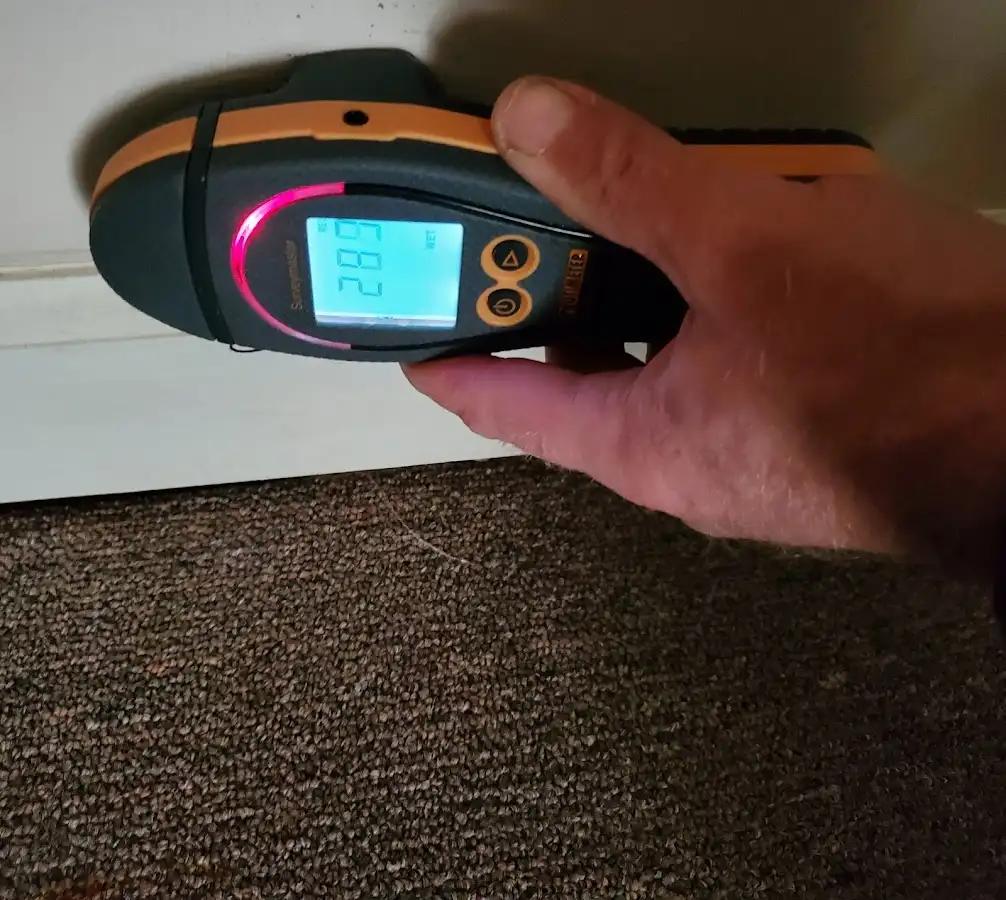 Moisture detection at baseboard during Storm Damage Restoration in Ballwin